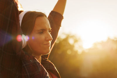 Young woman with arms raised