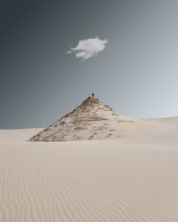 Sand dune at desert against sky