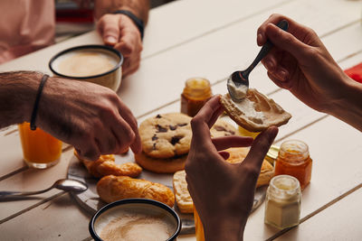 Midsection of person having food on table