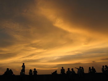 Silhouette of people at sunset