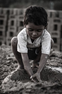 Cute boy playing with mud
