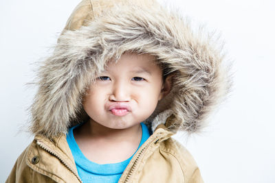 Portrait of cute boy wearing hooded jacket