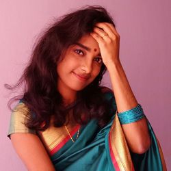 Portrait of a smiling young woman against wall