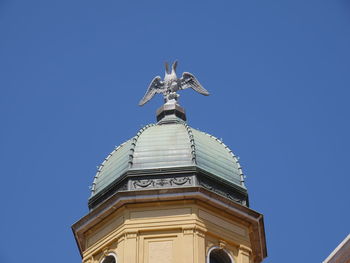 Low angle view of statue against blue sky