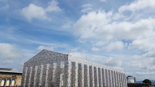 Low angle view of building against cloudy sky