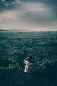 Rear view of man looking at mountain during dusk