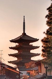 Low angle view of pagoda against sky in city