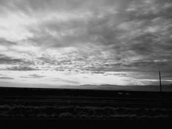 Scenic view of silhouette field against sky