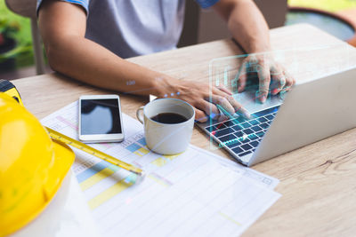 Midsection of man working on table