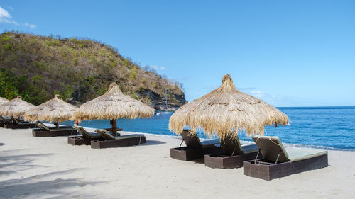 Scenic view of beach against clear blue sky