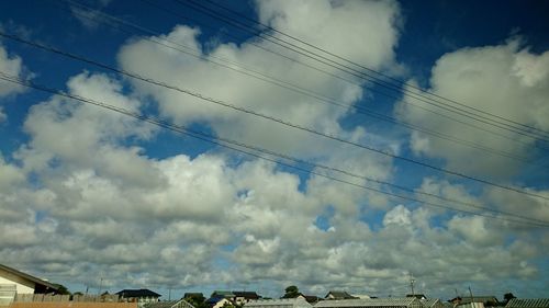 Low angle view of cables against sky