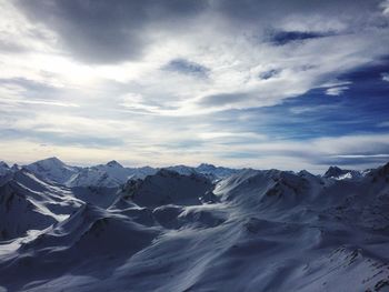 Scenic view of mountains against cloudy sky