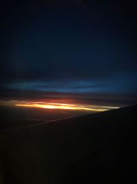 Scenic view of silhouette landscape against sky at sunset