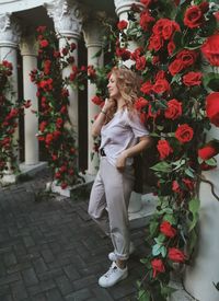 Woman standing by flowering plants