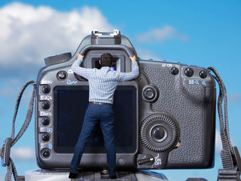 Man standing against blue sky