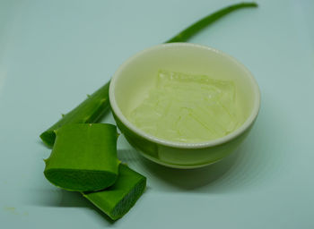 Close-up of green fruits and leaves on table