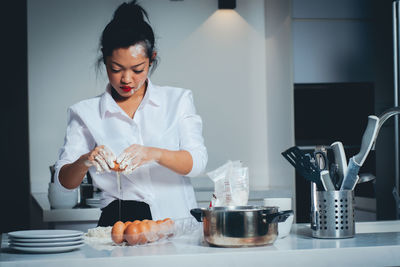 Woman holding ice cream at home