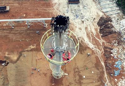 High angle view of workers on tower at construction site