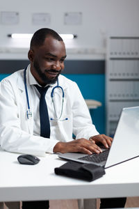 Doctor using laptop at clinic