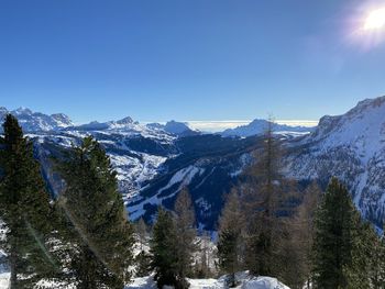 Scenic view of snowcapped mountains against clear sky