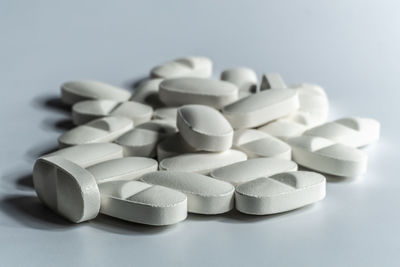 Close-up of stack on table against white background