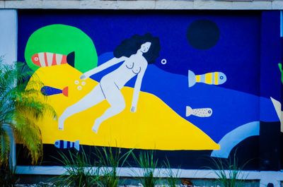 Close-up of yellow flag against blue sky