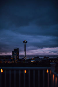 Dusk blue view of seattle skyline from rooftop deck with string lights