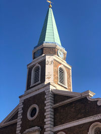 Low angle view of building against blue sky