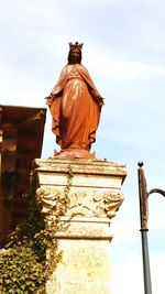 Low angle view of statue against sky