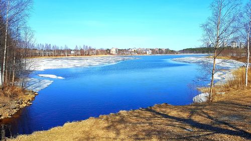 Scenic view of lake against blue sky