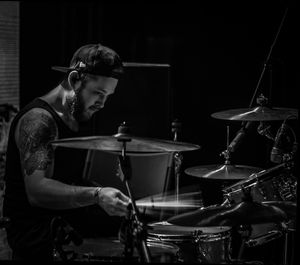 Performer playing drum kit at stage