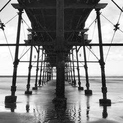 Silhouette of pier over sea against sky