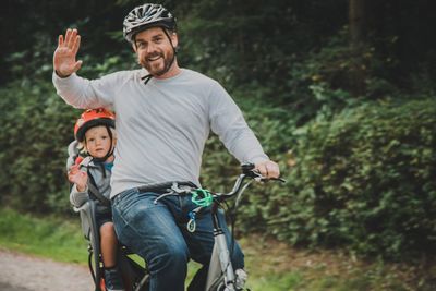 Full length of father and son riding horse