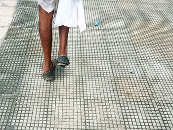 Low section of man walking on footpath