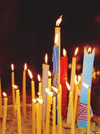 Close-up of lit candles in the dark