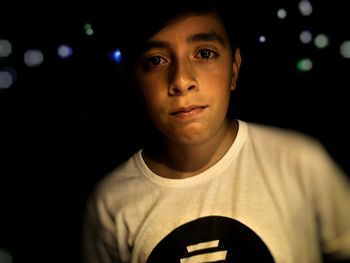 Close-up portrait of boy at night