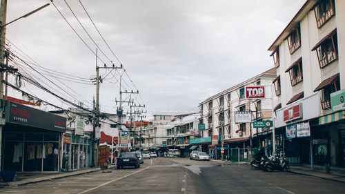 Street amidst buildings in city against sky