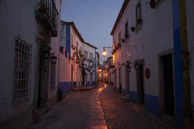 Narrow street amidst buildings in city