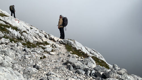 Man standing on rock against mountain