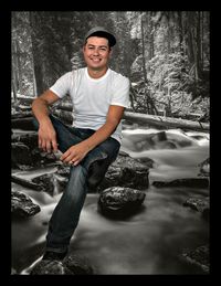 Portrait of smiling man standing on rock