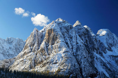 Scenic view of snowcapped mountains against blue sky