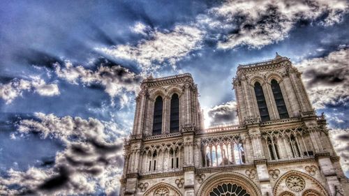 Low angle view of historical building against cloudy sky