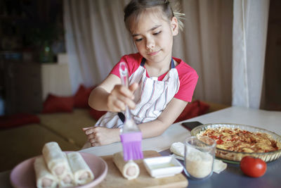 Midsection of woman having food at home