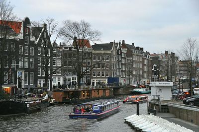 Boats in canal along buildings