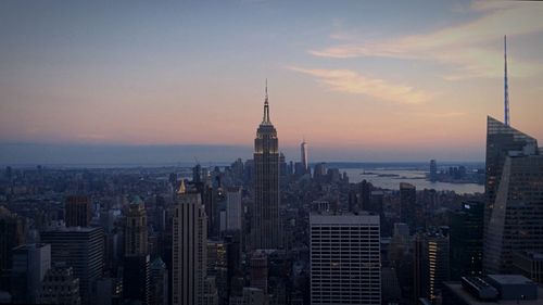 Skyscrapers in city at dusk