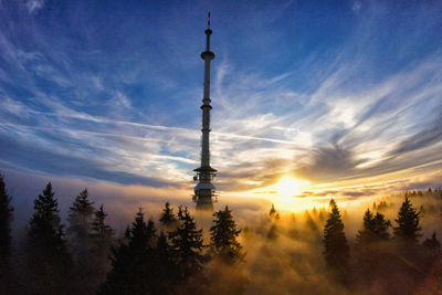 Silhouette tower against sky during sunset