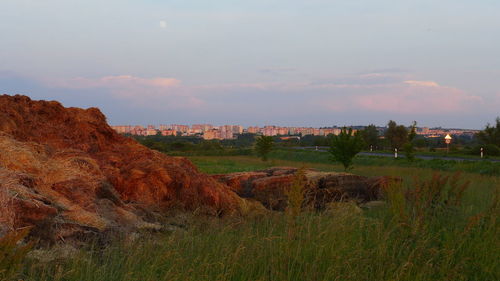 Scenic view of landscape against sky at sunset