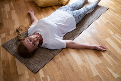 Low section of woman sitting on hardwood floor