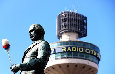 Low angle view of statue against clear blue sky