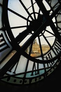 Low angle view of clock against sky